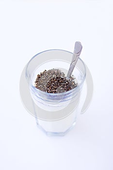 Chia seeds are drunk with airan from a glass. photo