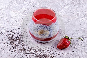 Chia seeds with fresh banana and strawberry in glass. Copy space