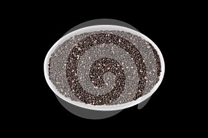 Chia seeds in a small white, oval ceramic bowl