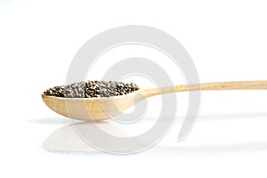 Chia seeds in wooden long spoon with reflexion isolated on white