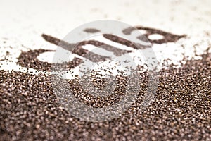 Chia word made from chia seeds Salvia hispanica on white background.