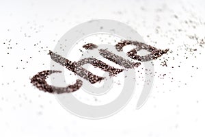 Chia word made from chia seeds Salvia hispanica on white background.