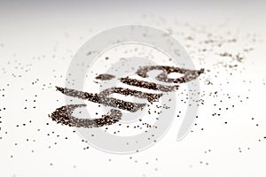 Chia word made from chia seeds Salvia hispanica on white background.