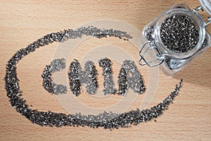 Chia word made from chia seeds on wooden plate