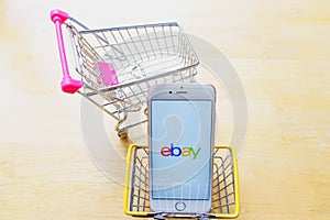 CHIANG MAI, THAILAND - Mar 02,2018: Apple iPhone 6S Rose Gold with eBay apps and shopping cart, shopping basket on the table.