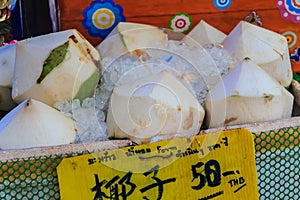 Chiang Mai, Thailand - May 3, 2017: Peeled young coconuts on ice