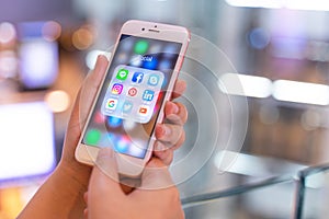 CHIANG MAI, THAILAND - May.10,2019: Woman holding Apple iPhone 6S Rose Gold with icons of social media on screen.