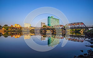 CHIANG MAI, THAILAND - NOVEMBER 8, 2022 : Reflection of Iron Bridge and colorful light lantern in sunrise. Loi Krathong or Yi Peng