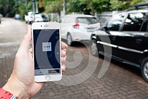 CHIANG MAI,THAILAND-SEP 02,2016 :A woman hand holding Uber application startup page on the Apple iPhone 6 display in female hand.