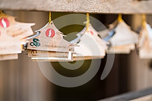 Chiang Rai, Thailand - January, 11, 2021 :  12 zodiac wooden planks in the shape of a house donation Label in Cherntawan