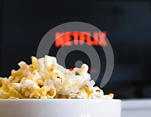 CHIANGMAI, THAILAND - JULY 4, 2019- Popcorn bowl and Netflix logo on Smart TV