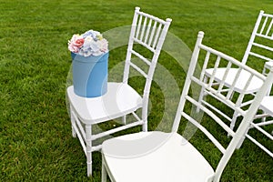 Chiavari chairs on grass.