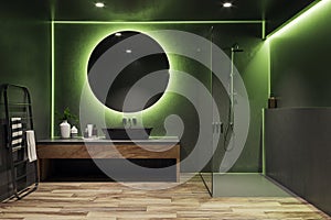 Chic bathroom interior with ambient lighting and round mirror. Modern luxury design.