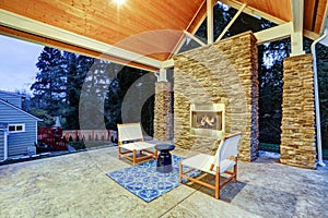 Chic covered back patio with built in gas fireplace