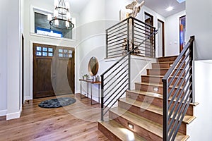 Chic entrance foyer with high ceiling and white walls.