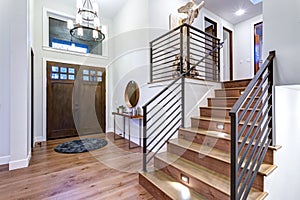 Chic entrance foyer with high ceiling and white walls. photo