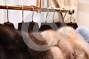 Chic expensive fur coats with natural fur on the hanger