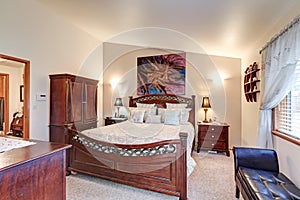 Chic master bedroom features vaulted ceiling