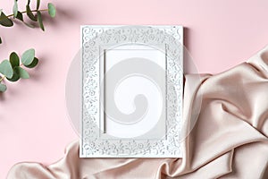 Chic photo frame mockup with eucalyptus and silk fabric on pink background. Flat lay, top view, copy space. Happy Mothers Day