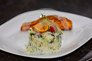 Chic plate of grilled salmon with broccoli rice garnished with fine herbs.