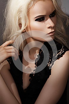 Chic rock style. Fashion blond model with make-up