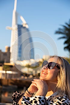 chic tourist sporting dark sunglasses and enjoying her stay in Dubai. Her modern attire exudes independence and