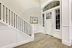 Chic white entryway design accented with high ceiling photo