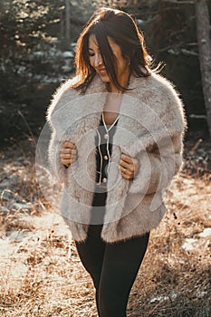 Chic winter shot featuring a beautiful woman in a fur jacket
