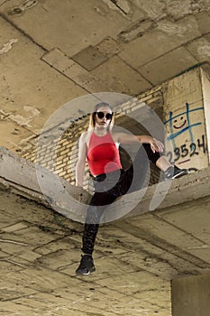 Chic woman posing at abandoned construction site
