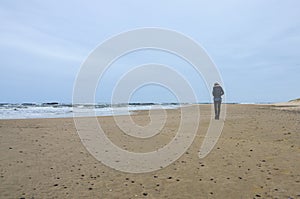 Girl walking alone at the beach. photo