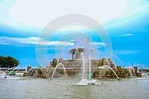 Chicago Buckingham fountain in Grant Park in the morning with cloud and blue sky.