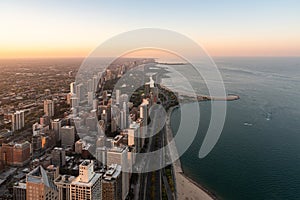 Chicago city skyscrapers aerial view, lake Michigan coastline during the sunset