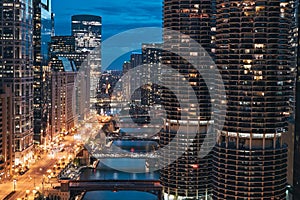 Chicago, Illinois. Cityscape, skyline at night with marina city tower, river, empty road and bridge in sight. Taken from London Ho photo