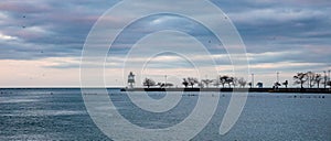 Chicago harbor light in the afternoon, blue lake water and sky background, banner