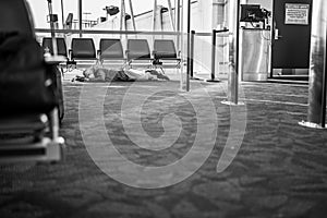 Chicago, IL - 4-8-2023: Passenger Resting on the Floor while awaiting a flight