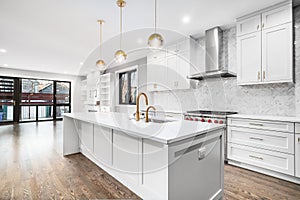 A modern luxurious kitchen with white and black cabinets.