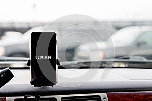 Chicago,IL,USA,Feb-21,2017,Smartphone attached to a car mount in car with Uber logo for editorial use only