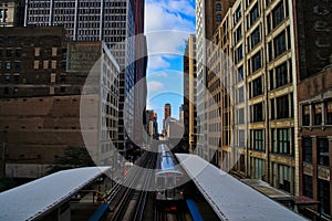 Chicago pink line elevated `el` train entering station located at the Adams Street and Wabash Avenue station in the downtown area photo