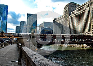 View from Wacker Drive as Purple Line elevated `el` train crosses Wells Street`s elevated track over the Chicago River