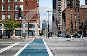 CHICAGO, ILLINOIS - APRIL 18, 2021: Downtown Chicago city street view background showing a blue cross walk near the South Loop