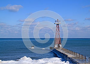 Chicago lighthouse juts out into a frozen Lake Michigan on a freezing winter day in January.