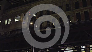 Chicago loop train passing by downtown apartment at night photo