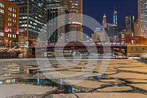 Chicago river downtown frozen ice buildings bridge night