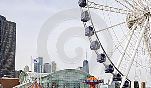 Chicago`s Navy Pier with the Ferris wheel and city skyline with skyscrapers in the background