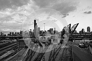 Chicago skyline with St. Charles Air Line Bridge. View from Amtrak Chicago Car Yard. Black and white.