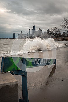 Chicago skyline view with blue wooden police barricades blocking off the lakefront trail or bike path due to high winds and