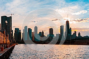 Chicago skyline viewed from the pier on Lake Michigan with sunset sky in the background