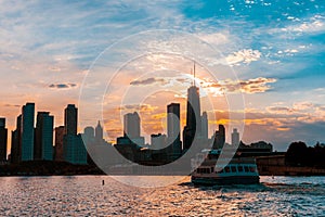 Chicago skyline viewed from the pier on Lake Michigan with sunset sky in the background