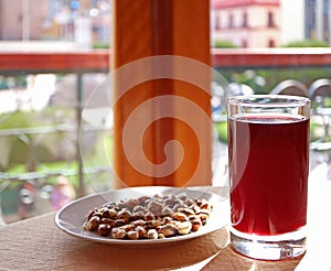 Chicha Morada, the Andean traditional beverage made from corn served with toasted corn kernels Cancha