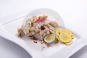 chicharon de pescado is ina peruvian food of fried marinated fish with onion aji and lemon.fried banana peruvian food